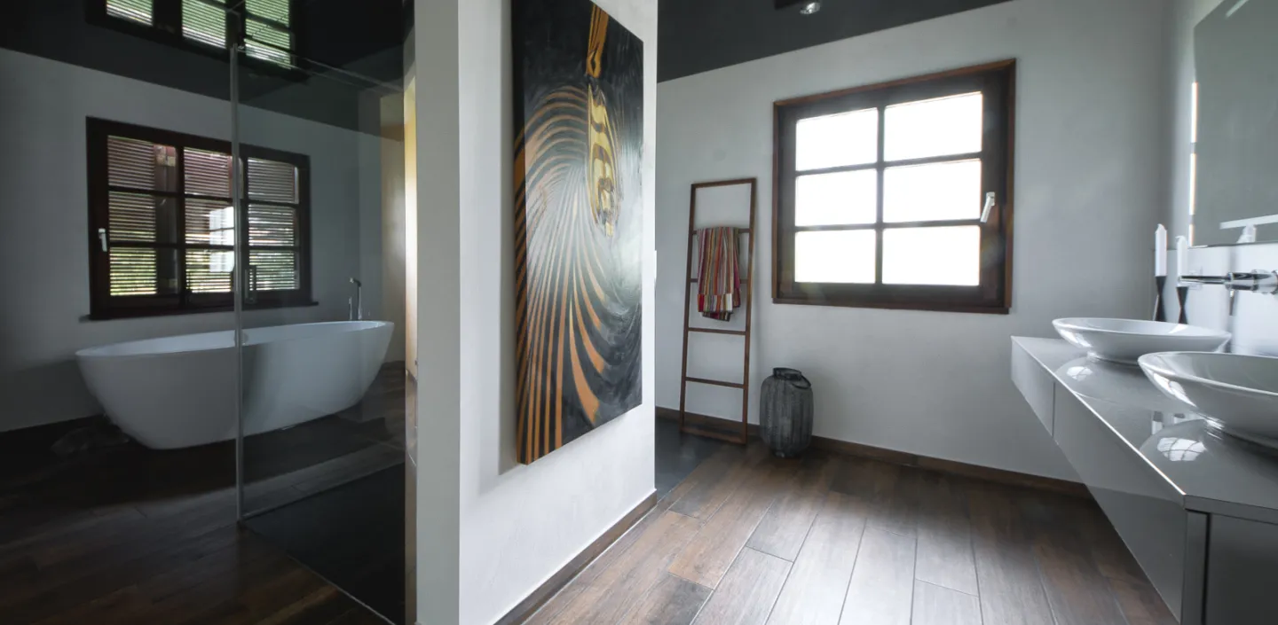 Bild eines geräumigen Badezimmers mit freistehender Acryl-Badewanne und bodenebener Dusche.