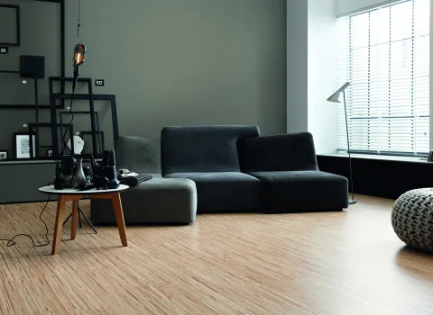 Foto eines gemütlichen Wohnzimmers mit Couch und der Wandfarbe Manhattan.