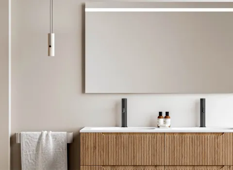 Header mit Waschtisch und Badschrank aus Holz, Leuchtspiegel und Hängelampen.