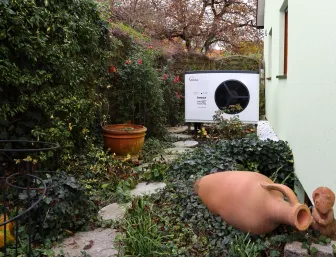 Solvis Lea Wärmepumpe im Garten neben einer Doppelhaushälfte.